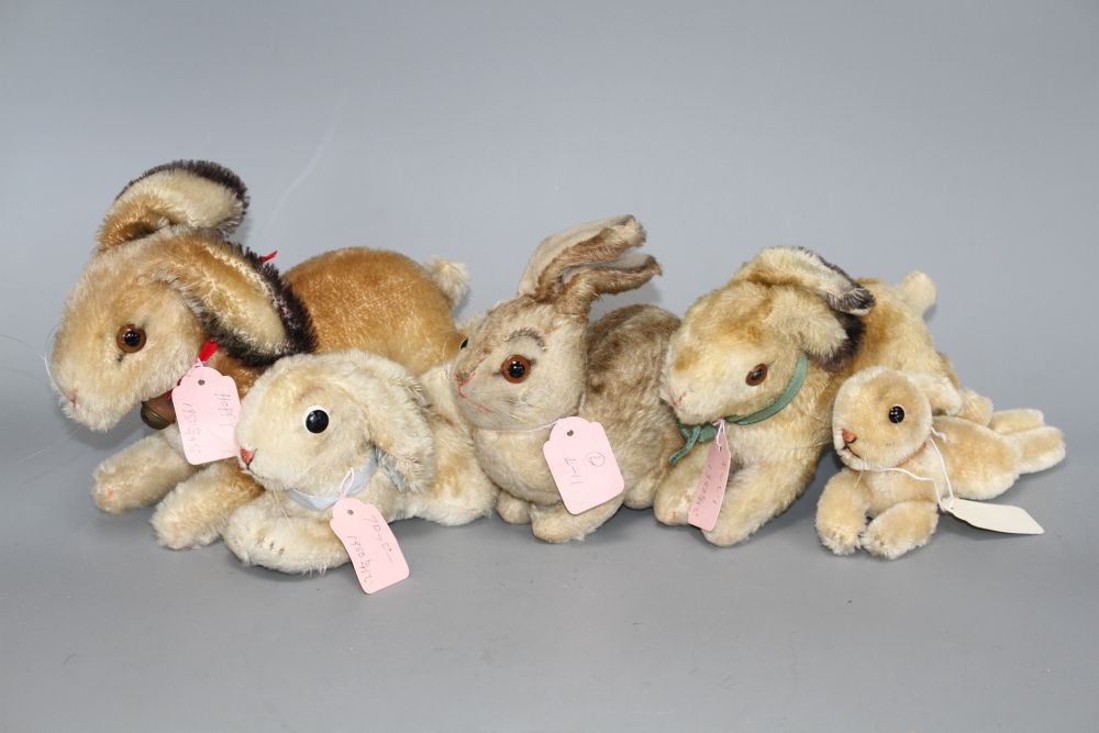 Two 1950s Steiff Hoppy rabbits, 23cm and 18cm, a 1940s Pummy rabbit, 15cm, and two lying rabbits, 20cm and 15cm